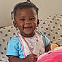 Makiyha joined the competition — help win amazing prizes! toddler, child, smiling, indoor, bib, blue_shirt, plush_toy, couch, patterned_couch, beads, hair_ties, happy, cute, baby, portrait, sitting, infant, hand, face, young_child
