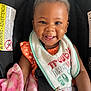 Makiyha joined the competition — help win amazing prizes! baby, smiling, bib, car_seat, blanket, child, happy, infant, clothing, face, portrait, seatbelt, pink_blanket, cute, sitting, earrings, orange_dress, indoor, person, closeup