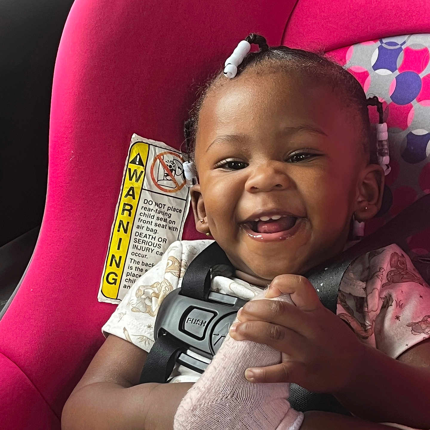 Makiyha is registered to the contest to win money with this photo: toddler, child, car_seat, smiling, braided_hair, beads, sock, seatbelt, happy, infant, cute, playful, portrait, safety, colorful, pattern, clothing, baby, indoor, seat