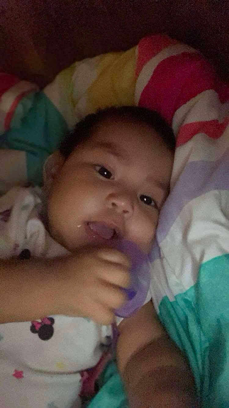 Amaria joined the competition — help win amazing prizes! baby, child, face, hand, blanket, colorful, indoor, infant, person, cute, young, sleeping, resting, soft, comfort, pajamas, toy, closeup, portrait, relaxed