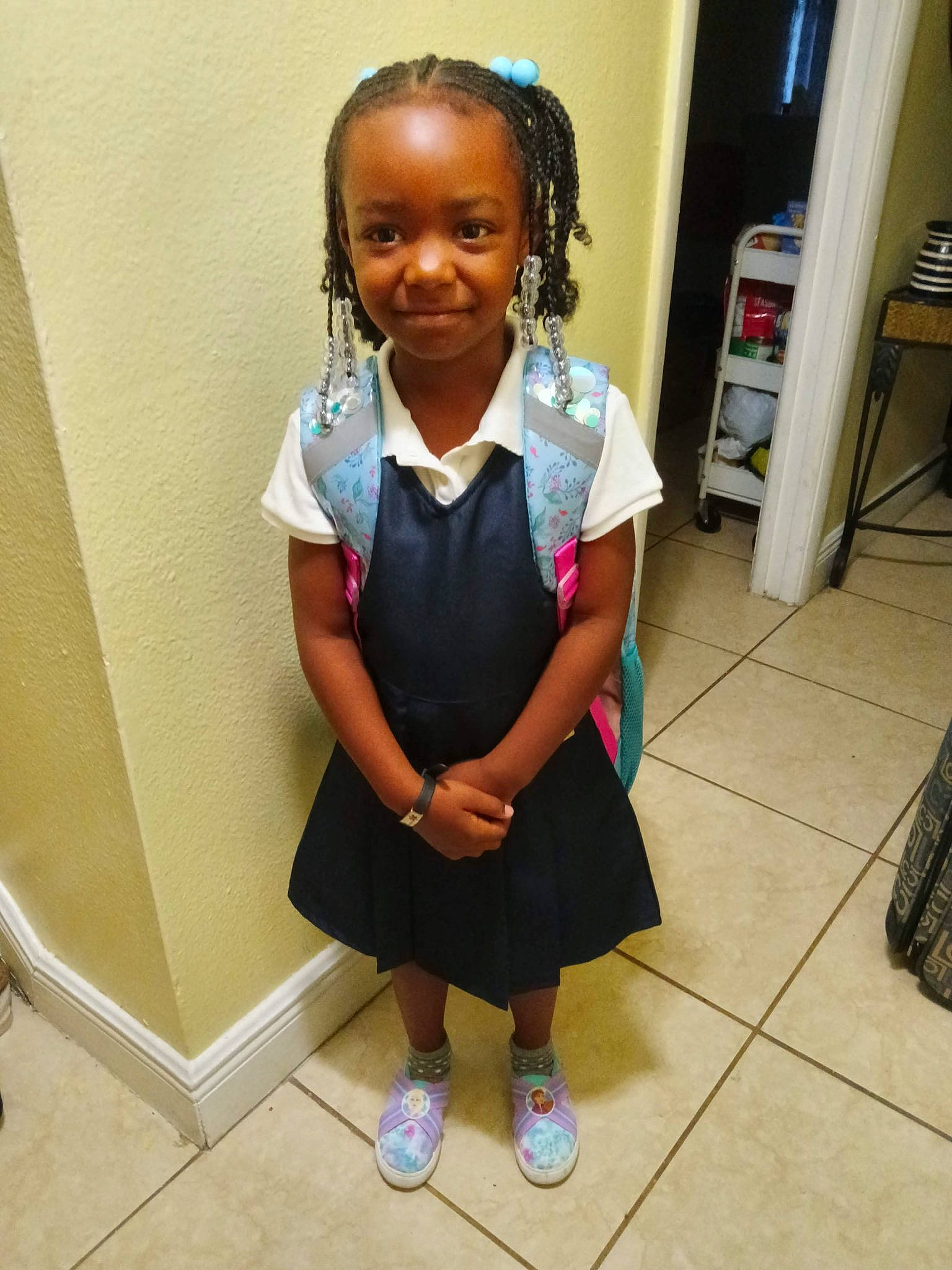 Antonia Amarriana Gwyn is registered to the contest to win money with this photo: black_hair, bookcase, cabinetry, child, electric_blue, flooring, fun, happy, joy, knee, pattern, person, room, sandal, school_uniform, shelf, sleeve, smile, sock, toddler