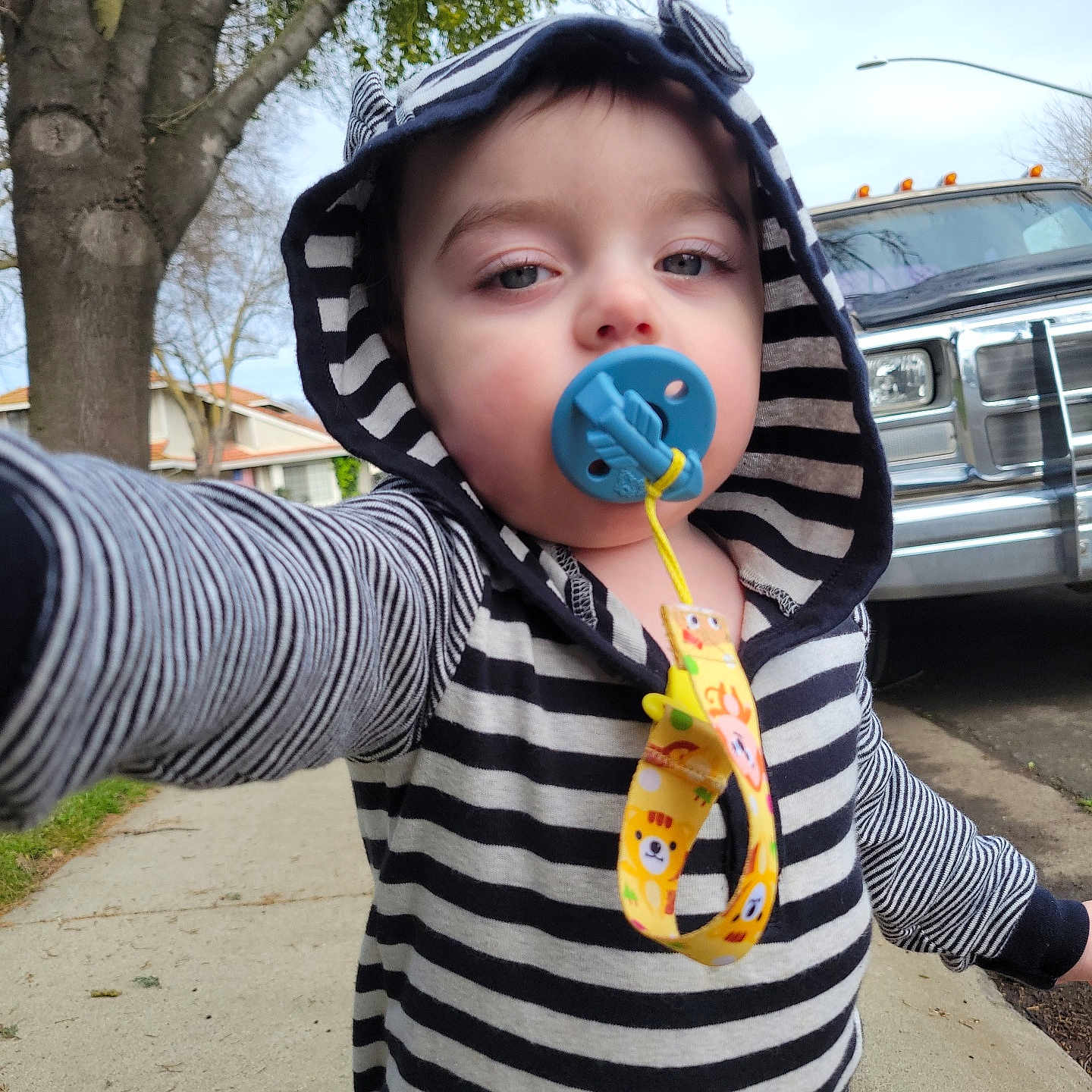 Cole is registered to the contest to win money with this photo: baby, bodypart, car, clothing, coat, face, finger, hand, hat, head, hood, hoodie, jacket, knitwear, person, photography, portrait, sweater, transportation, vehicle