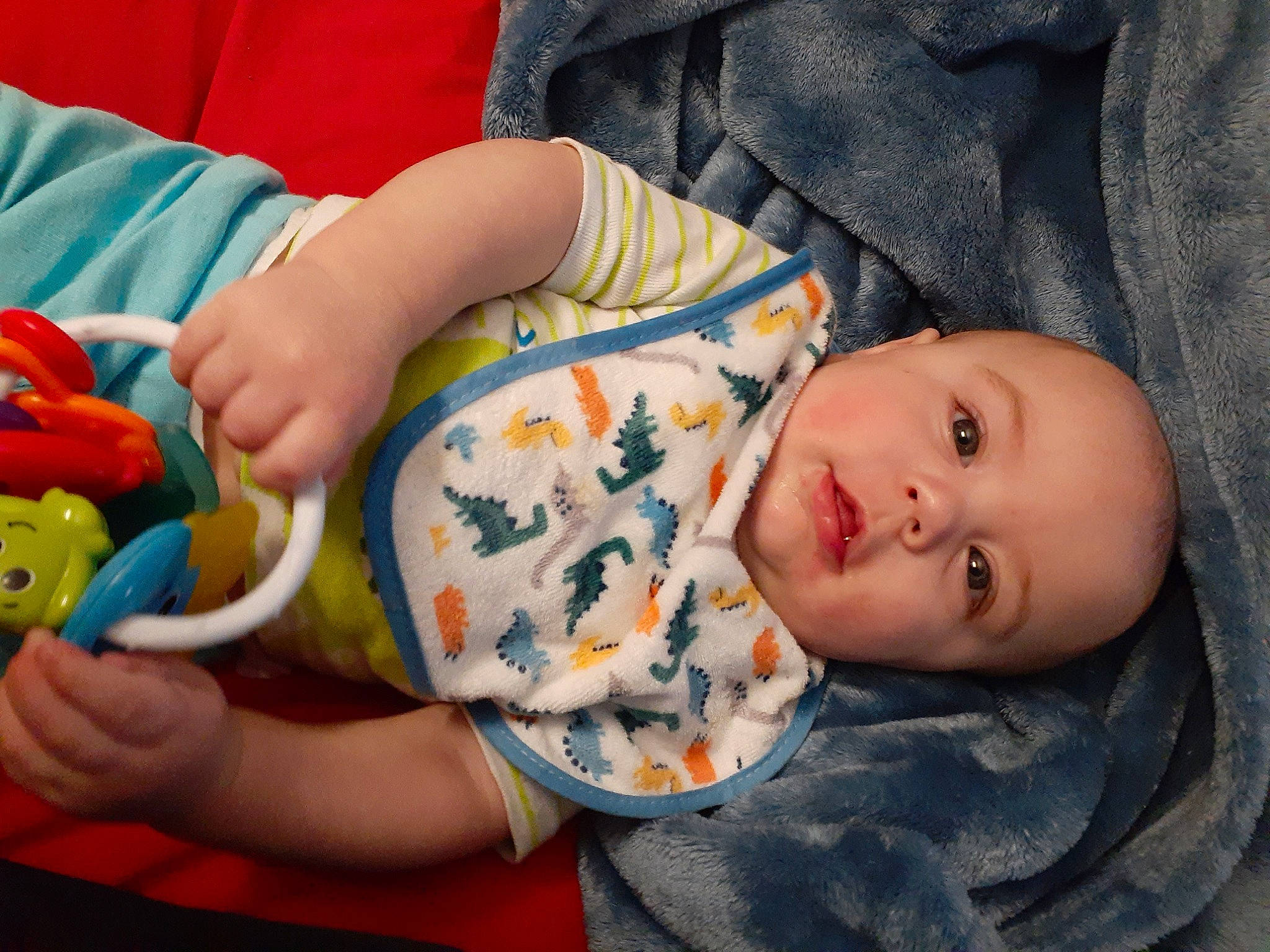 Callum is registered to the contest to win money with this photo: arm, baby, baby_toddler_clothing, cheek, comfort, finger, hand, head, headwear, human_body, iris, mouth, nose, orange, organ, people, person, product, skin, sleeve