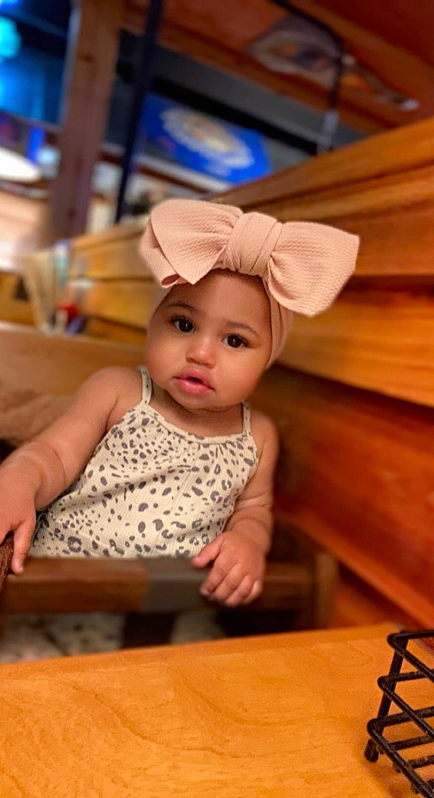 Wynter is registered to the contest to win money with this photo: baby, baby_toddler_clothing, chair, cheek, child, eye, fashion_accessory, flooring, fun, happy, hardwood, hat, headwear, person, room, sitting, skin, table, tableware, toddler