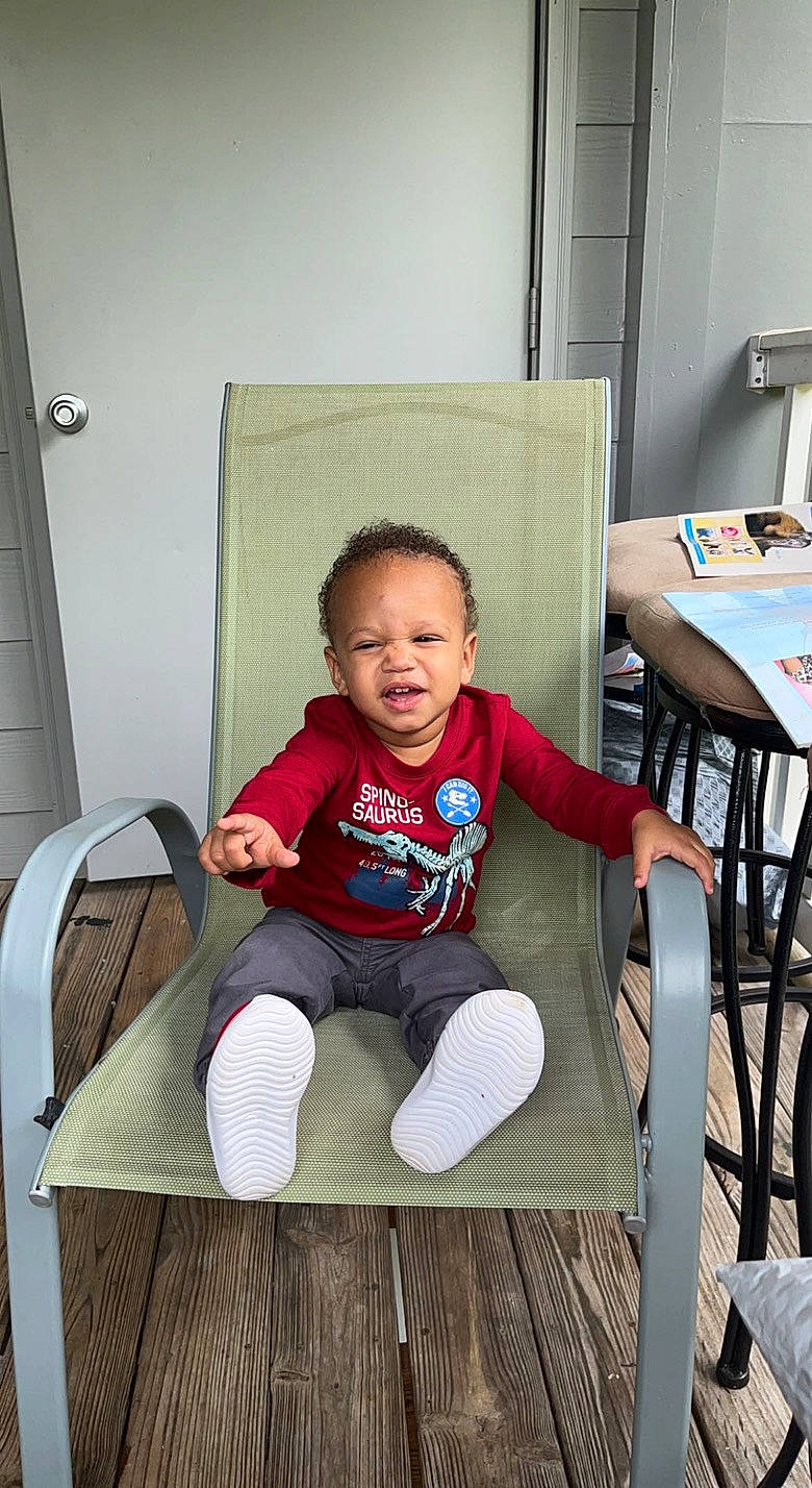 Roman joined the competition — help win amazing prizes! baby_toddler_clothing, chair, child, comfort, door, flooring, furniture, happy, hardwood, leg, leisure, person, room, sitting, sleeve, smile, t_shirt, table, thigh, toddler
