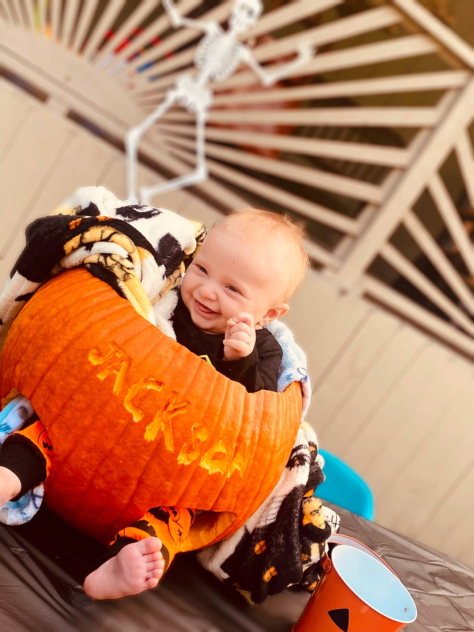 Jackson is registered to the contest to win money with this photo: baby, baby_products, baby_toddler_clothing, bag, calabaza, child, comfort, flooring, fun, happy, joy, leisure, luggage_and_bags, orange, person, pumpkin, recreation, sitting, smile, toddler
