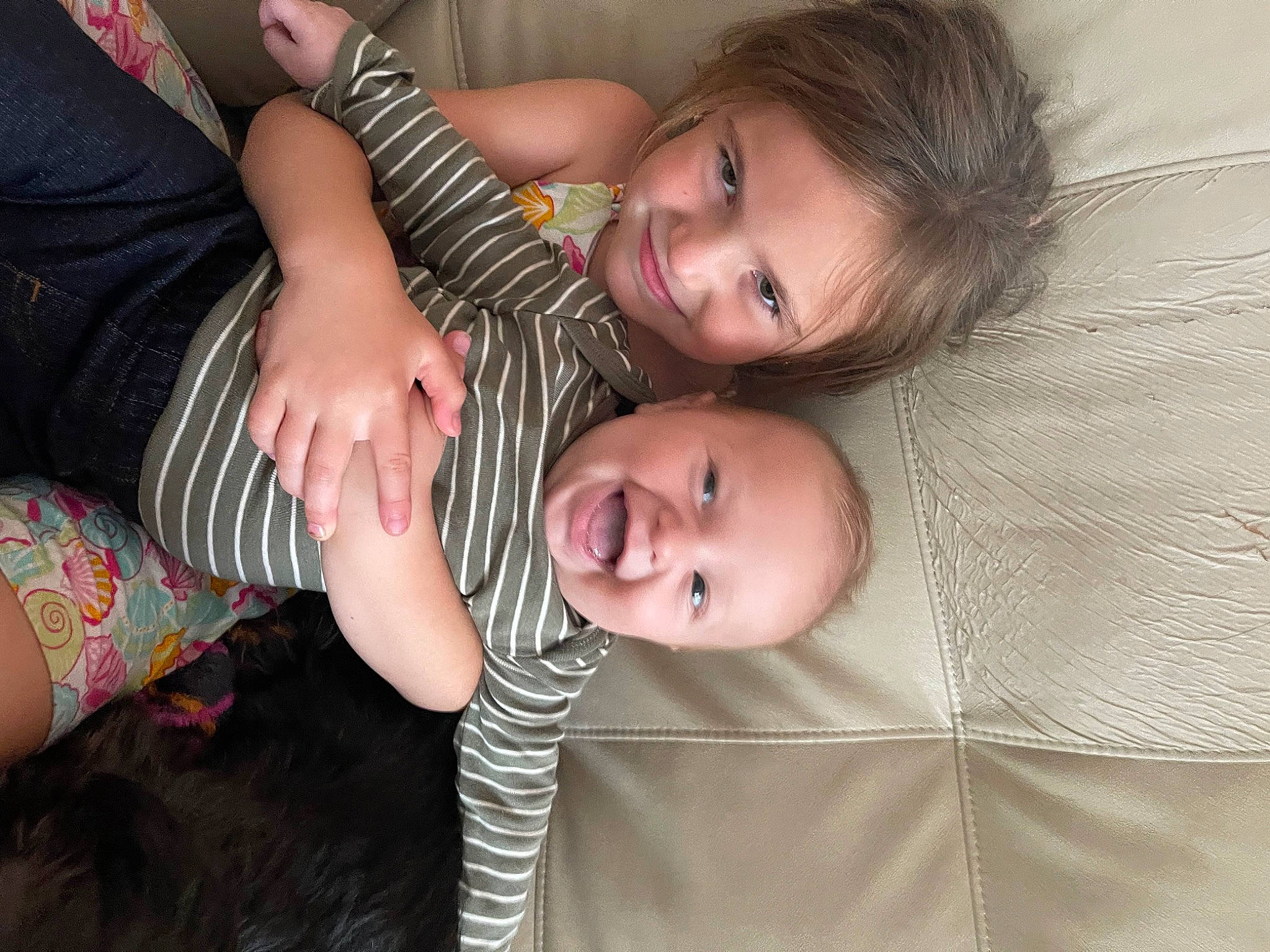 Jackson is registered to the contest to win money with this photo: baby, child, comfort, couch, eye, flash_photography, fun, gesture, grass, happy, head, human_leg, joy, pattern, person, sitting, skin, smile, thigh, toddler