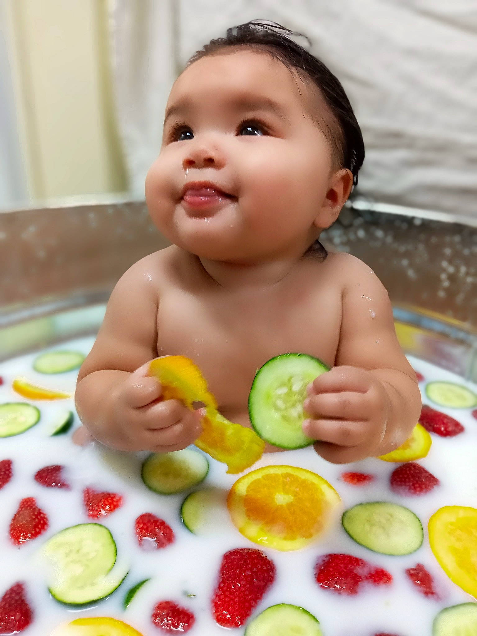 Sarahi is registered to the contest to win money with this photo: arm, baby, baby_playing_with_toys, cheek, food, food_craving, fruit, green, happy, ingredient, joy, lip, mouth, natural_foods, nose, person, produce, skin, smile, tableware