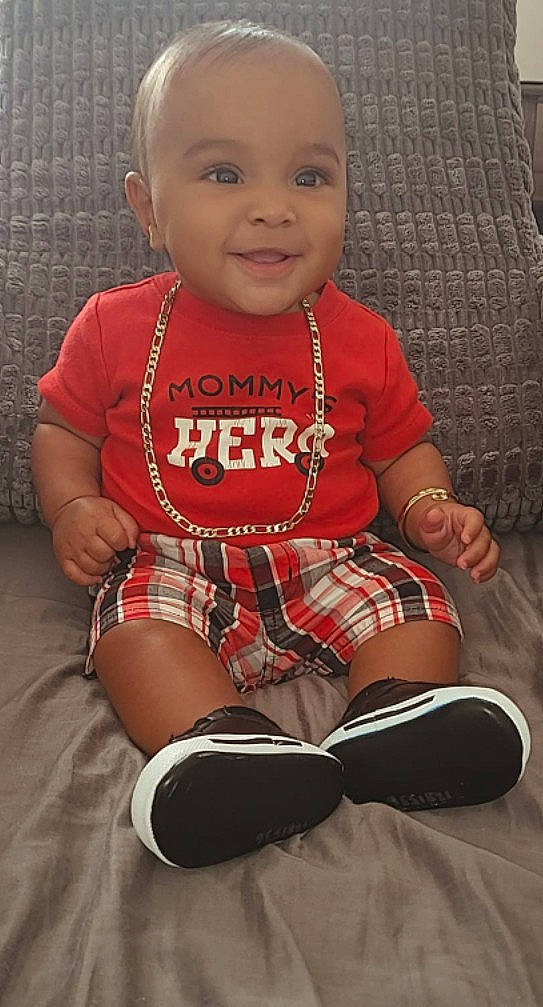 Joey joined the competition — help win amazing prizes! baby, bracelet, casual_clothing, chair, child, close_up, cozy, fashion, gold_chain, happy, indoor, infant, plaid_shorts, playful, portrait, red_shirt, short_hair, sitting, smiling, sneakers