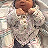 newborn, baby, infant, blanket, headband, hospital_wristband, sleeping, clothing, purple, floral, cozy, cute, person, indoors, wrapped, soft, resting, child, newborn_clothes, peaceful