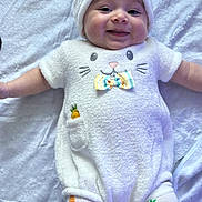 Ezme is registered to the contest to win money with this photo: baby, smiling, infant, white_outfit, bunny_ears, bow_tie, carrot_pattern, leggings, soft_blanket, cute, happy, child, one_person, portrait, indoors, apparel, headwear, playful, toddler, baby_clothes