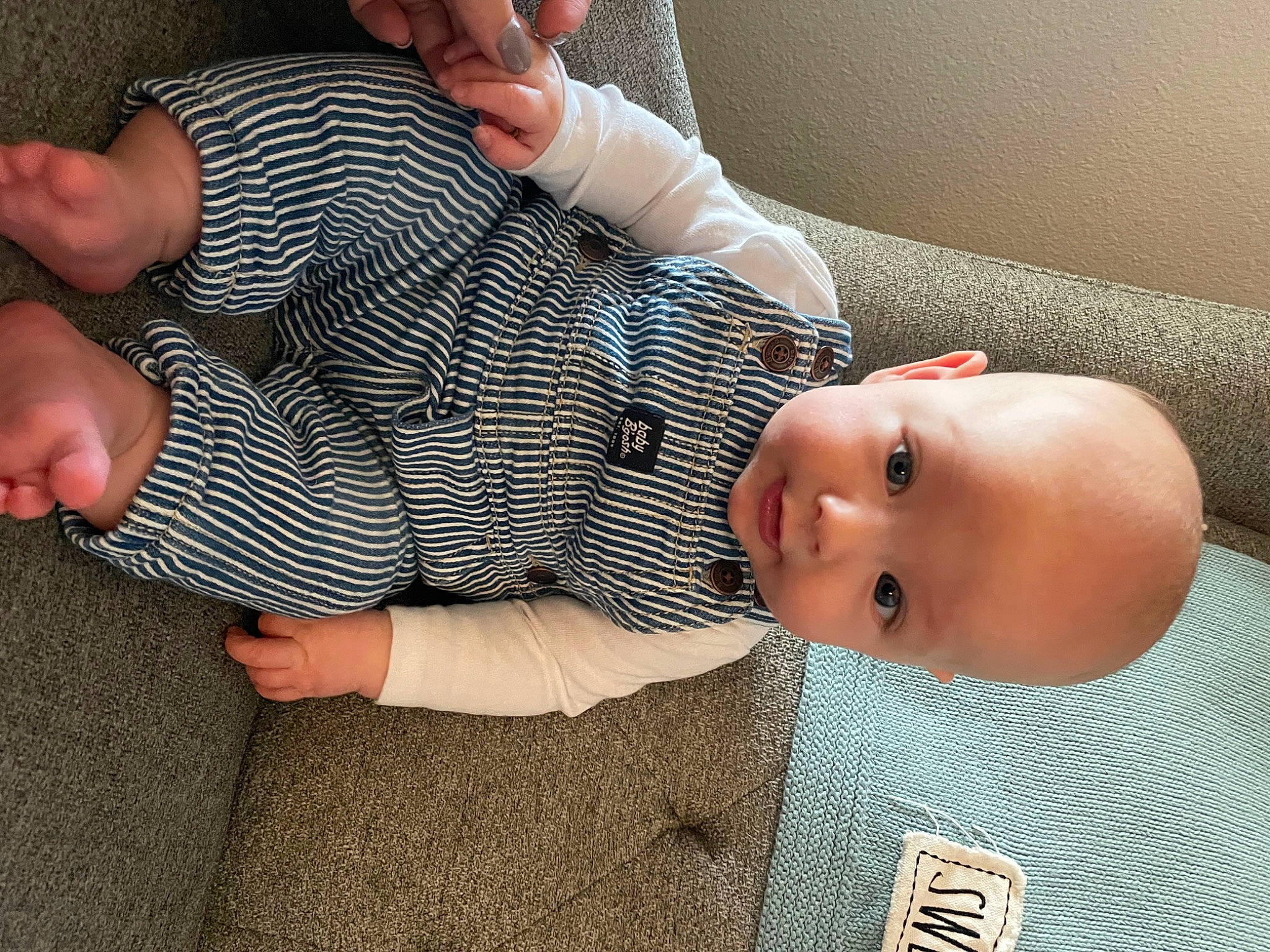 Kason is registered to the contest to win money with this photo: arm, baby, baby_toddler_clothing, cheek, comfort, face, finger, gesture, hand, head, human_body, joint, leg, mouth, muscle, nose, person, skin, sleeve, thumb