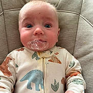 Elijah joined the competition — help win amazing prizes! baby, infant, onesie, dinosaur_pattern, bubbles, face, wide_eyes, cushion, seat, clothing, hand, warning_label, indoor, cute, expression, child, portrait, soft_lighting, close_up, skin