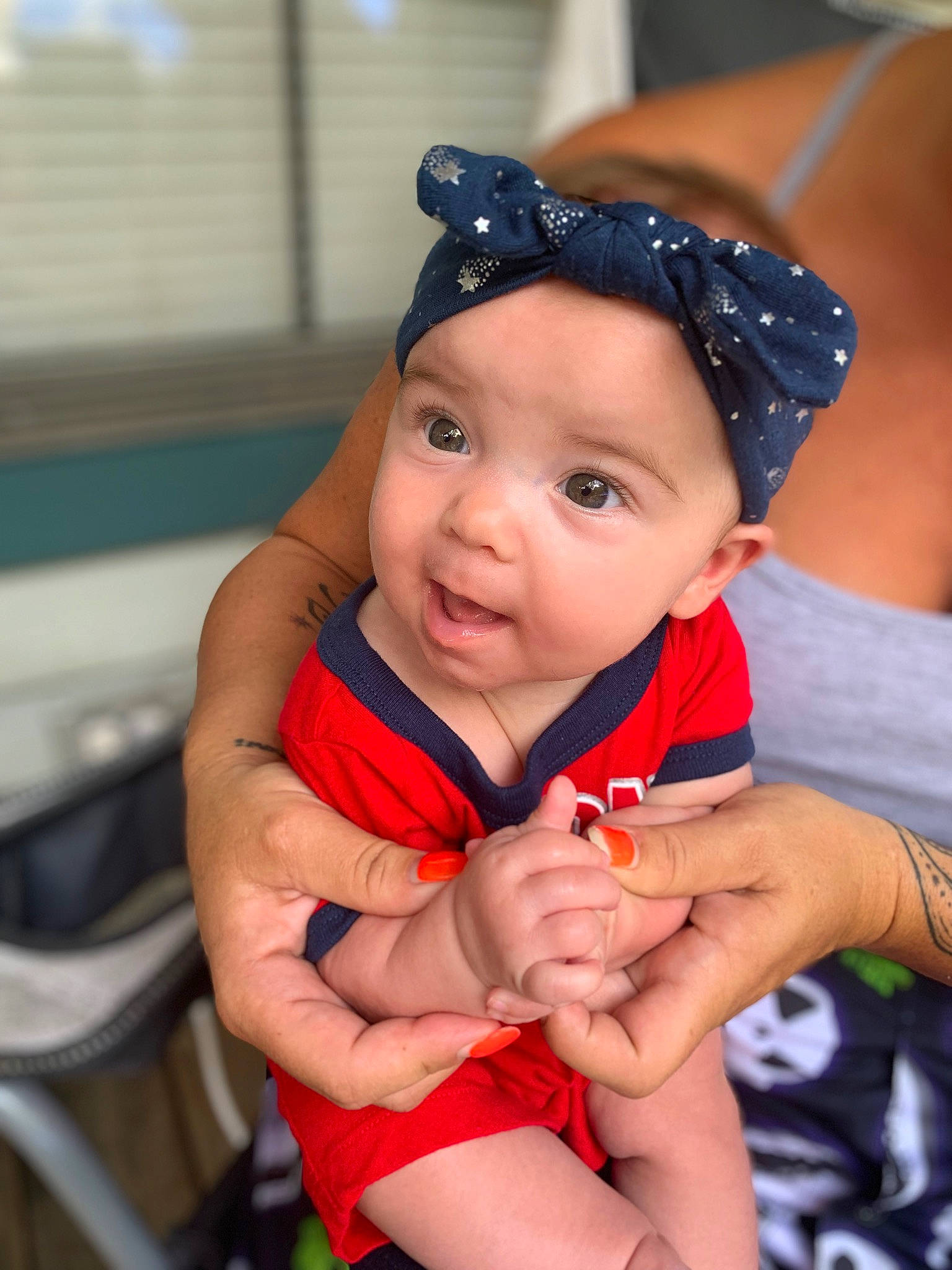 Elodie is registered to the contest to win money with this photo: baby, baby_products, baby_toddler_clothing, cap, child, chin, electric_blue, face, finger, fun, hand, happy, hat, headwear, human_leg, lip, person, sitting, thigh, thumb