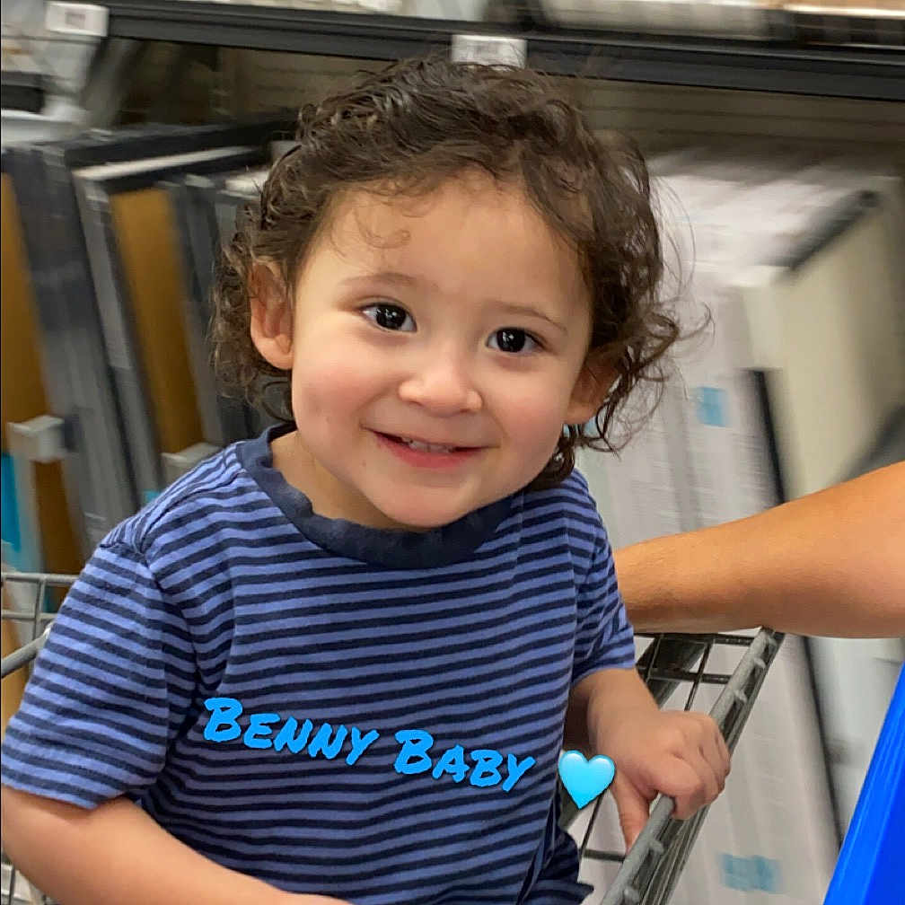 Benjamin joined the competition — help win amazing prizes! accessories, baby, bodypart, book, bracelet, clothing, face, finger, hand, happy, head, indoors, jewelry, library, person, photography, portrait, publication, smile, t_shirt