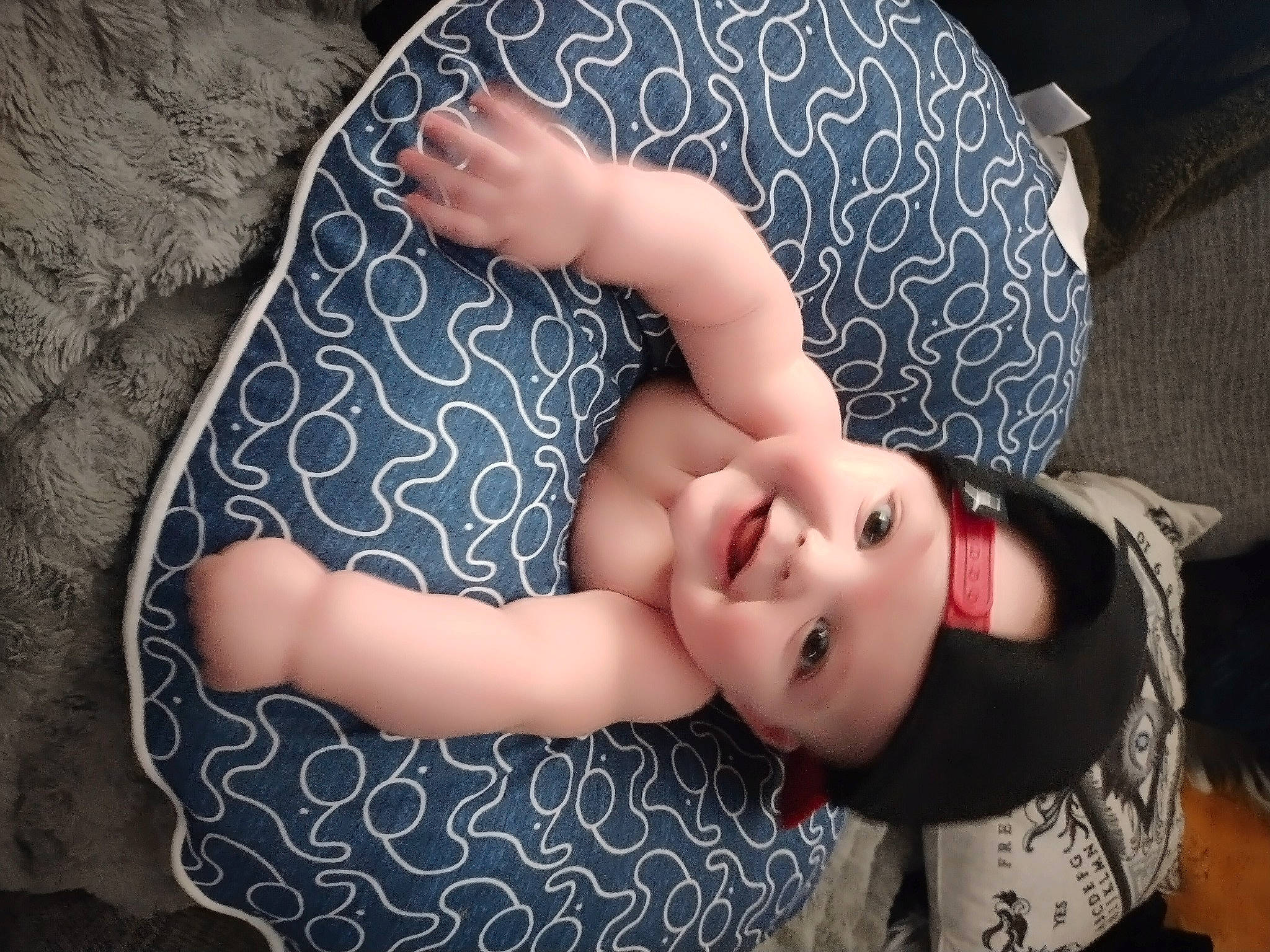 Junior is registered to the contest to win money with this photo: arm, baby, baby_toddler_clothing, dress, elbow, finger, flash_photography, gesture, grass, happy, headwear, human_body, joy, leg, lip, nail, neck, pattern, person, shoulder