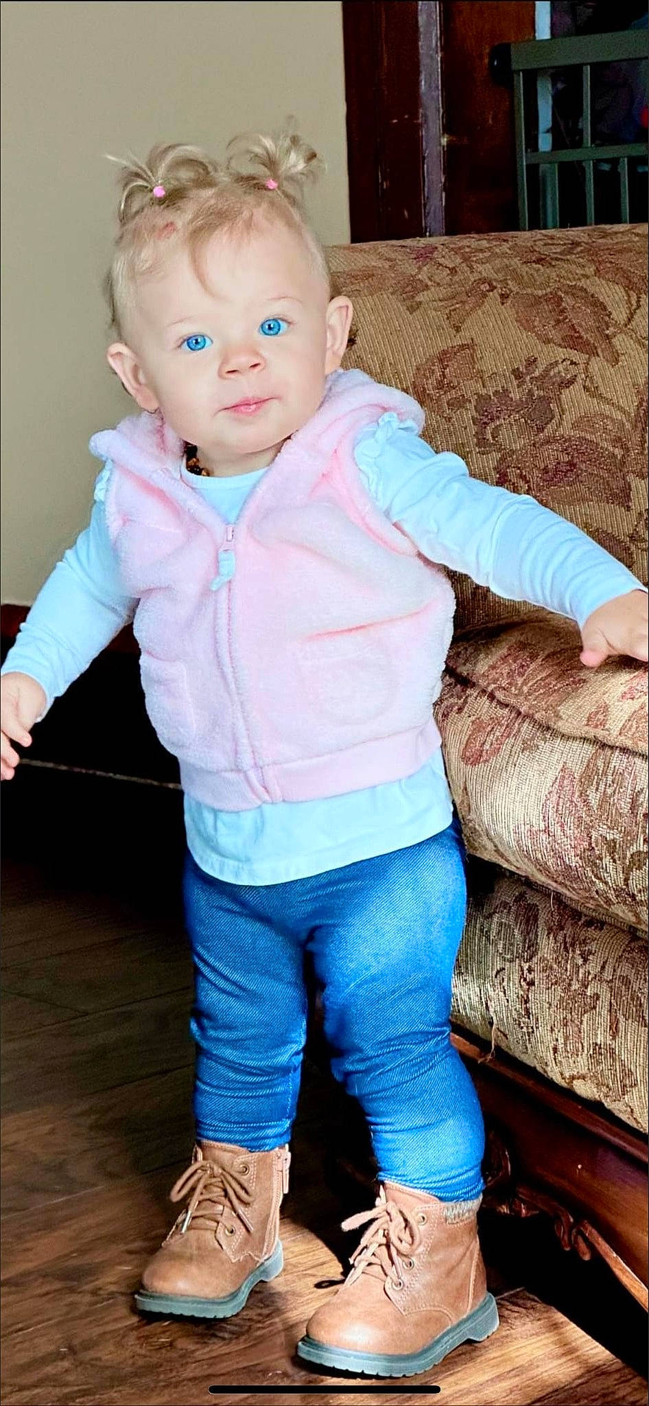 Remington is registered to the contest to win money with this photo: baby, baby_products, baby_toddler_clothing, blue, cheek, child, couch, denim, electric_blue, gesture, happy, magenta, neck, nose, pattern, person, sitting, skin, sleeve, t_shirt