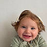 Elyanna joined the competition — help win amazing prizes! baby, child, infant, portrait, smiling, happy, face, blue_eyes, pigtails, hair_bows, rosy_cheeks, green_outfit, zipper, indoor, wall, close_up, sitting, adorable, joyful, photography