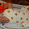 newborn, baby, infant, hospital, bassinet, onesie, pumpkin_pattern, orange_booties, pacifier, sleeping, lying_down, medical_equipment, tubing, blanket, portrait, indoor, nursery, crib, birth, newborn_care