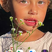 Camryn is registered to the contest to win money with this photo: bodypart, child, cosmetics, daisy, face, female, finger, flower, girl, hand, happy, head, lipstick, mouth, person, photography, plant, portrait, smelling, smile