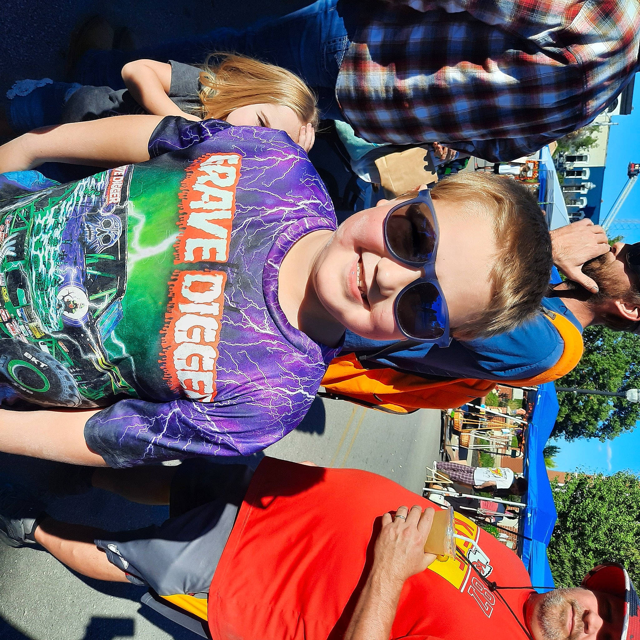 Ryder is registered to the contest to win money with this photo: blue, elbow, entertainment, event, eyewear, fun, gesture, goggles, hairstyle, happy, headwear, joy, leisure, pattern, person, public_event, recreation, sleeve, smile, sunglasses