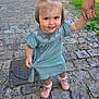 Paola a rejoint le concours — aidez-le/la à gagner de superbes lots ! adult_hand, child, cobblestone, cute, dress, footwear, grass, greenery, happy, holding_hand, nature, outdoor, person, pigtails, pink_shoes, playful, portrait, sidewalk, smiling, toddler