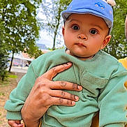 Aadvik Kushwaha is registered to the contest to win money with this photo: baby, child, person, hand, cap, clothing, outdoor, nature, trees, greenery, cute, portrait, young, face, skin, expression, holding, sleeve, background, daylight