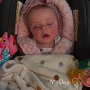Paislee is registered to the contest to win money with this photo: baby, sleeping, blanket, car_seat, headband, toy, pacifier, infant, cozy, child, pink, soft, cute, peaceful, indoors, polka_dot, face, apparel, comfort, resting