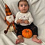 Angelica joined the competition — help win amazing prizes! baby, blanket, child, clothing, cute, decor, face, foot, gnome, halloween, holiday, indoors, orange, pants, portrait, pumpkin, shirt, sitting, toy, white