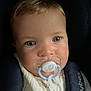 baby, pacifier, blue_eyes, car_seat, infant, close_up, child, cute, face, young, seatbelt, comfort, soft_lighting, portrait, clothing, safety, indoors, expressionless, adorable, baby_gear
