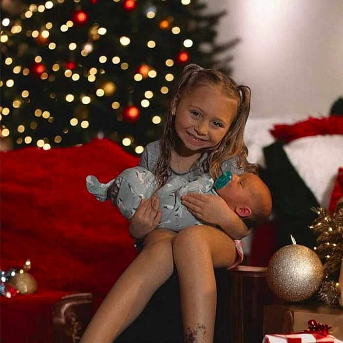 Aleigha joined the competition — help win amazing prizes! brownhair, child, christmas, christmasdecorations, christmastree, face, female, festival, girl, hair, happy, head, hugging, lighting, openingpresent, person, smile