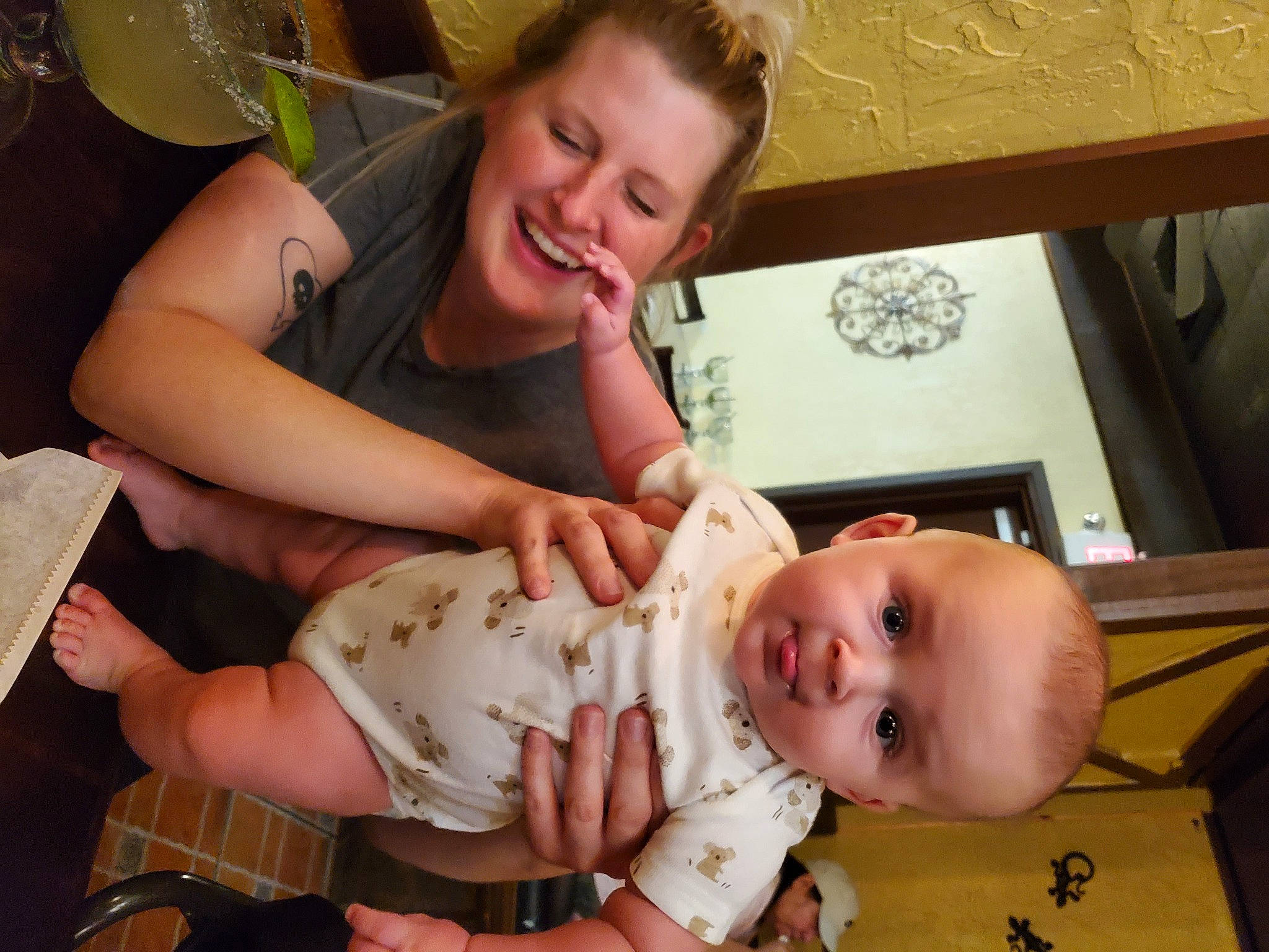 Achilles is registered to the contest to win money with this photo: arm, baby, baby_toddler_clothing, cheek, child, comfort, finger, fun, hand, happy, headwear, joy, nail, person, room, sitting, skin, smile, thigh, thumb