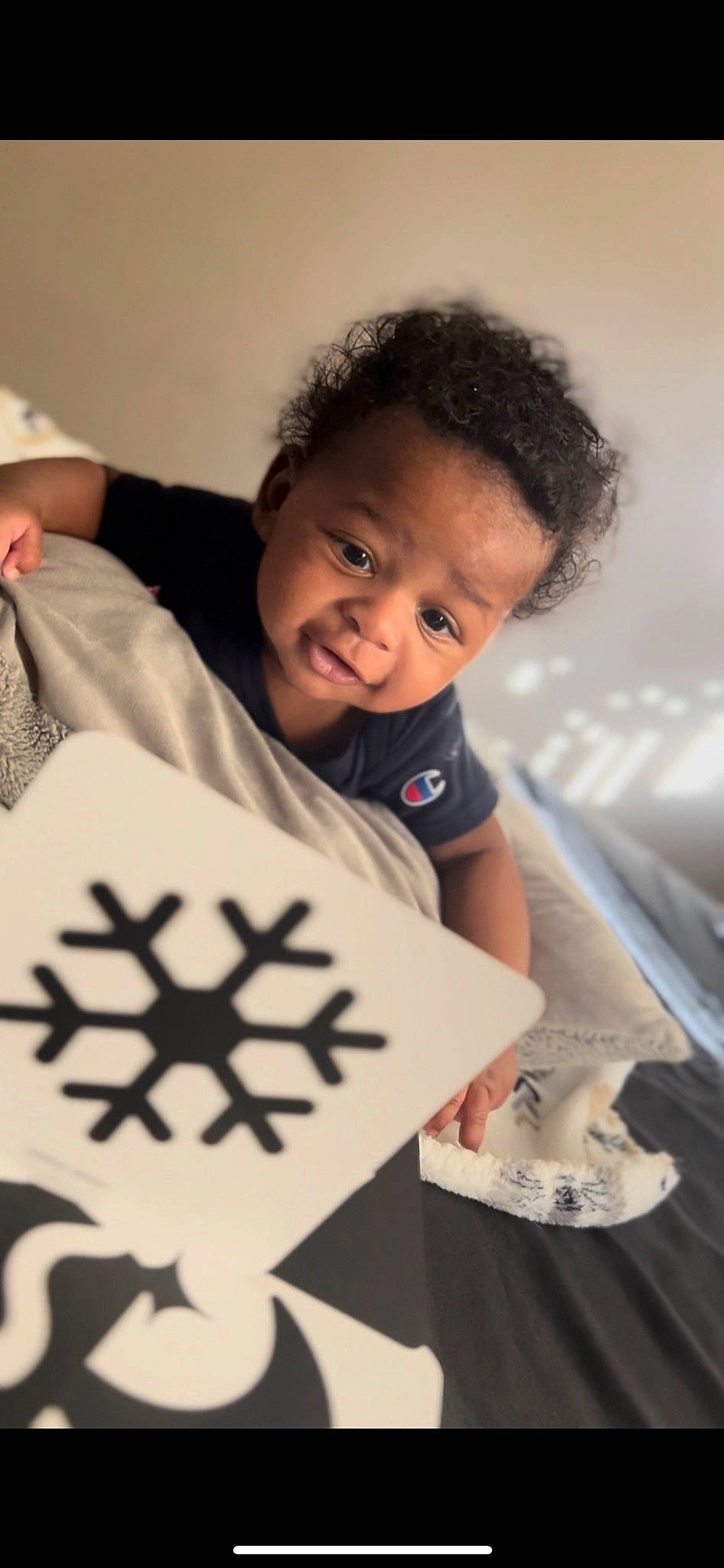 Amiri is registered to the contest to win money with this photo: arm, baby, child, cool, cross, elbow, finger, flash_photography, flooring, font, fun, gesture, hair, happy, organ, person, sleeve, smile, snapshot, t_shirt