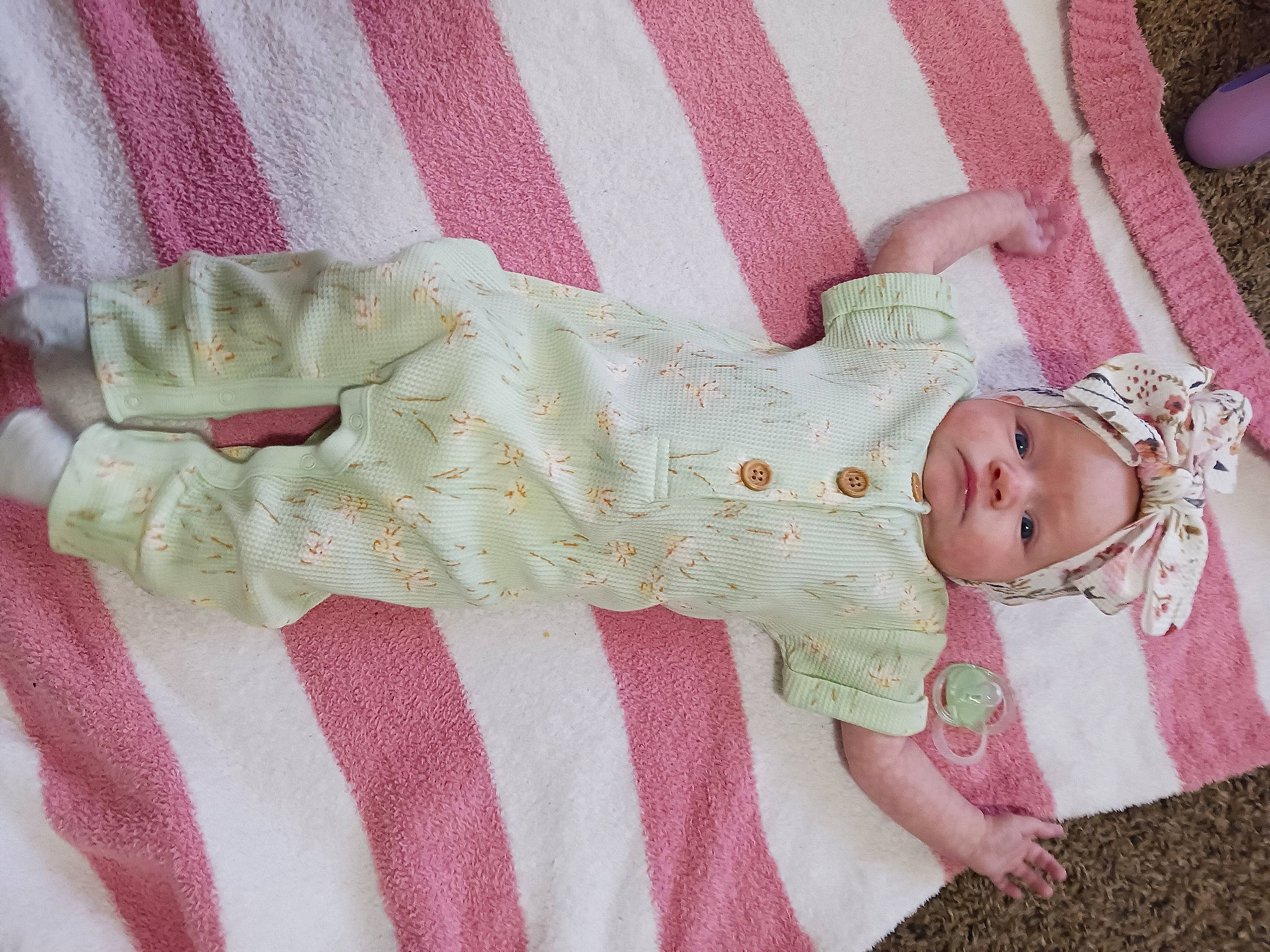 Grace is registered to the contest to win money with this photo: baby, baby_products, baby_toddler_clothing, child, comfort, craft, creative_arts, dress, embellishment, fashion_accessory, hair_accessory, headwear, linens, magenta, pattern, person, pink, sleeve, sock, textile