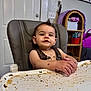 baby, high_chair, messy, food, face, hands, tray, indoor, child, curly_hair, expression, seat, skin, person, furniture, table, smile, cute, home, meal