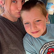Robert is registered to the contest to win money with this photo: child, boy, adult, woman, selfie, portrait, smiling, family, indoors, window, sunlight, t_shirt, cartoon, mario, close_up, face, hair, happy, casual, photograph