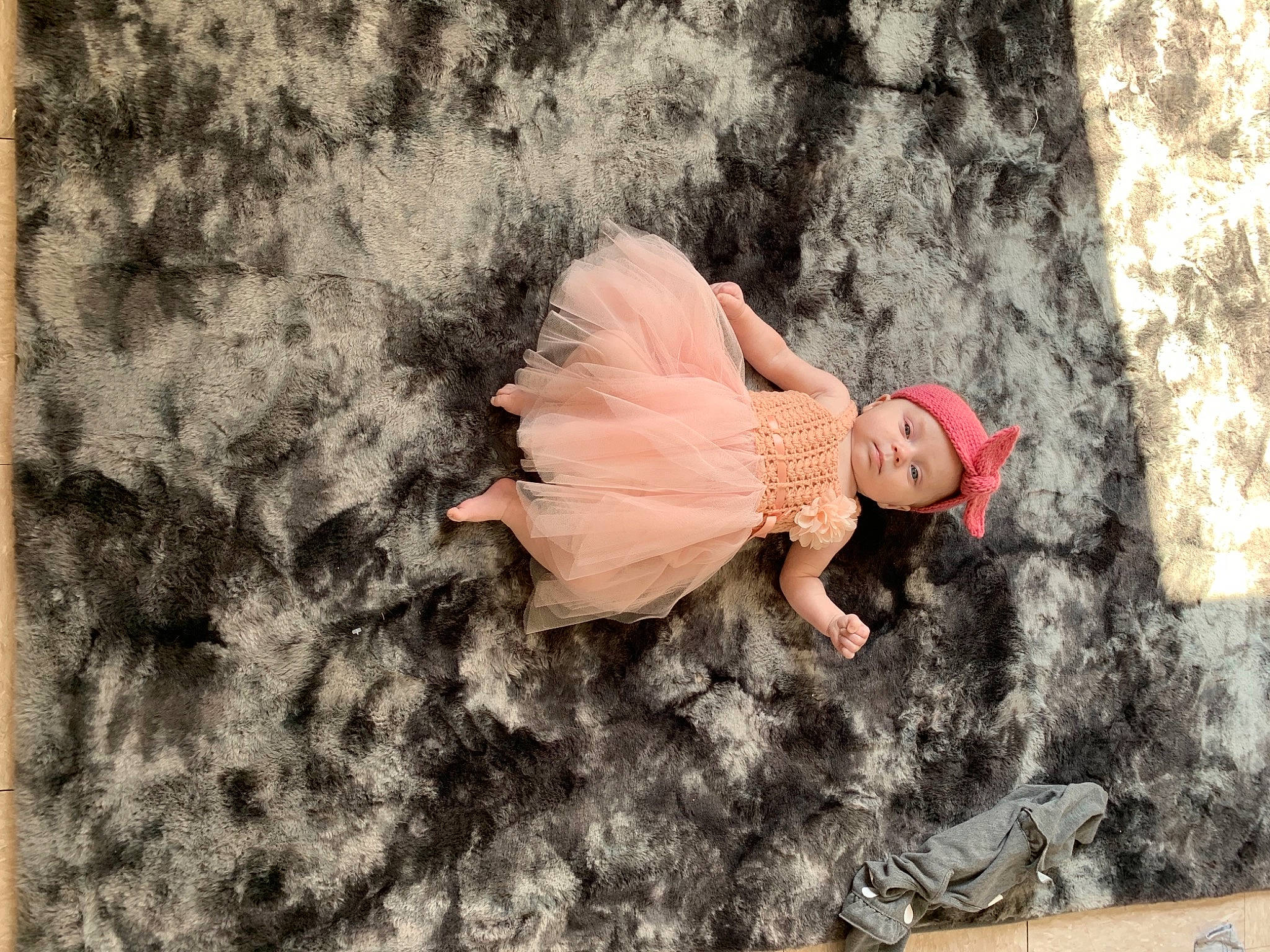 Emerie is registered to the contest to win money with this photo: arm, doll, fawn, fun, gesture, grass, hand, happy, head, headwear, human_body, landscape, mythical_creature, organism, peach, people_in_nature, person, petal, soil, toy