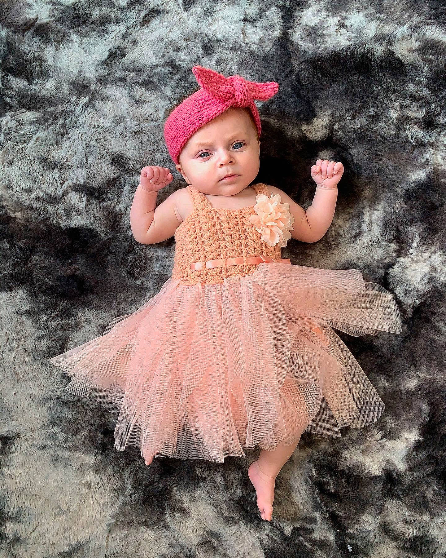 Emerie is registered to the contest to win money with this photo: baby, baby_toddler_clothing, cap, costume_hat, day_dress, doll, dress, embellishment, happy, headgear, headpiece, headwear, magenta, mythical_creature, pattern, peach, person, pink, ruffle, skin