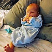 Zayden is registered to the contest to win money with this photo: baby, bed, blanket, clothing, comfort, cozy, cute, face, foot, hand, indoors, infant, newborn, pacifier, person, pillow, portrait, resting, sleepwear, soft_lighting