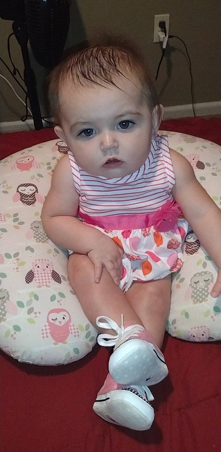 Salice is registered to the contest to win money with this photo: arm, baby_toddler_clothing, cheek, chin, eye, face, hairstyle, hand, head, human_body, iris, leg, lip, mouth, neck, nose, organ, person, skin, sleeve