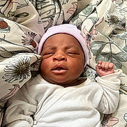 Erriyah joined the competition — help win amazing prizes! baby, newborn, infant, sleeping, hat, white_clothing, blanket, floral_pattern, peaceful, cute, fist, indoors, child, portrait, soft, cozy, resting, person, closeup, headwear
