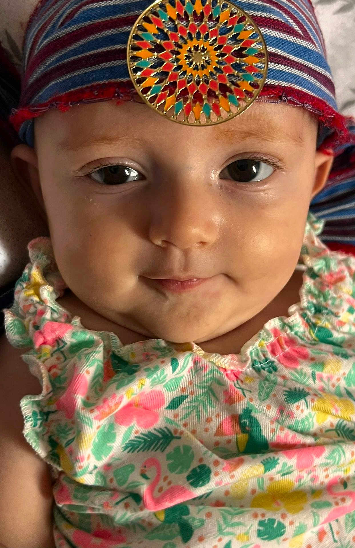 Aysena participe au concours pour gagner de l'argent avec cette photo : baby, face, portrait, headscarf, colorful, ornament, clothing, floral_pattern, cute, child, smile, closeup, infant, skin, eyes, person, fashion, headwear, expression, young