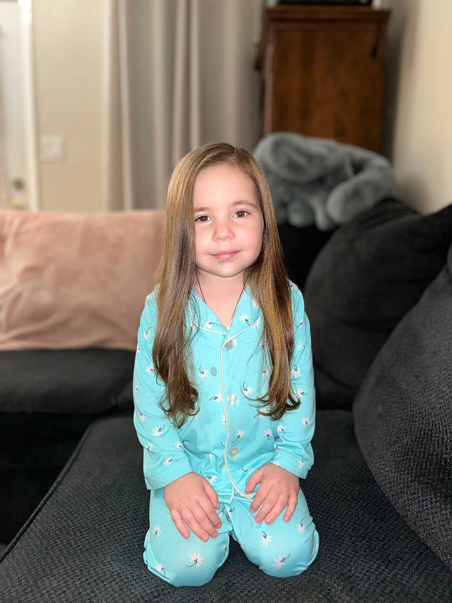 Helen Marie is registered to the contest to win money with this photo: arm, baby_toddler_clothing, brown_hair, cheek, comfort, couch, electric_blue, eye, flooring, happy, head, iris, joy, living_room, long_hair, person, sitting, skin, sleeve, smile