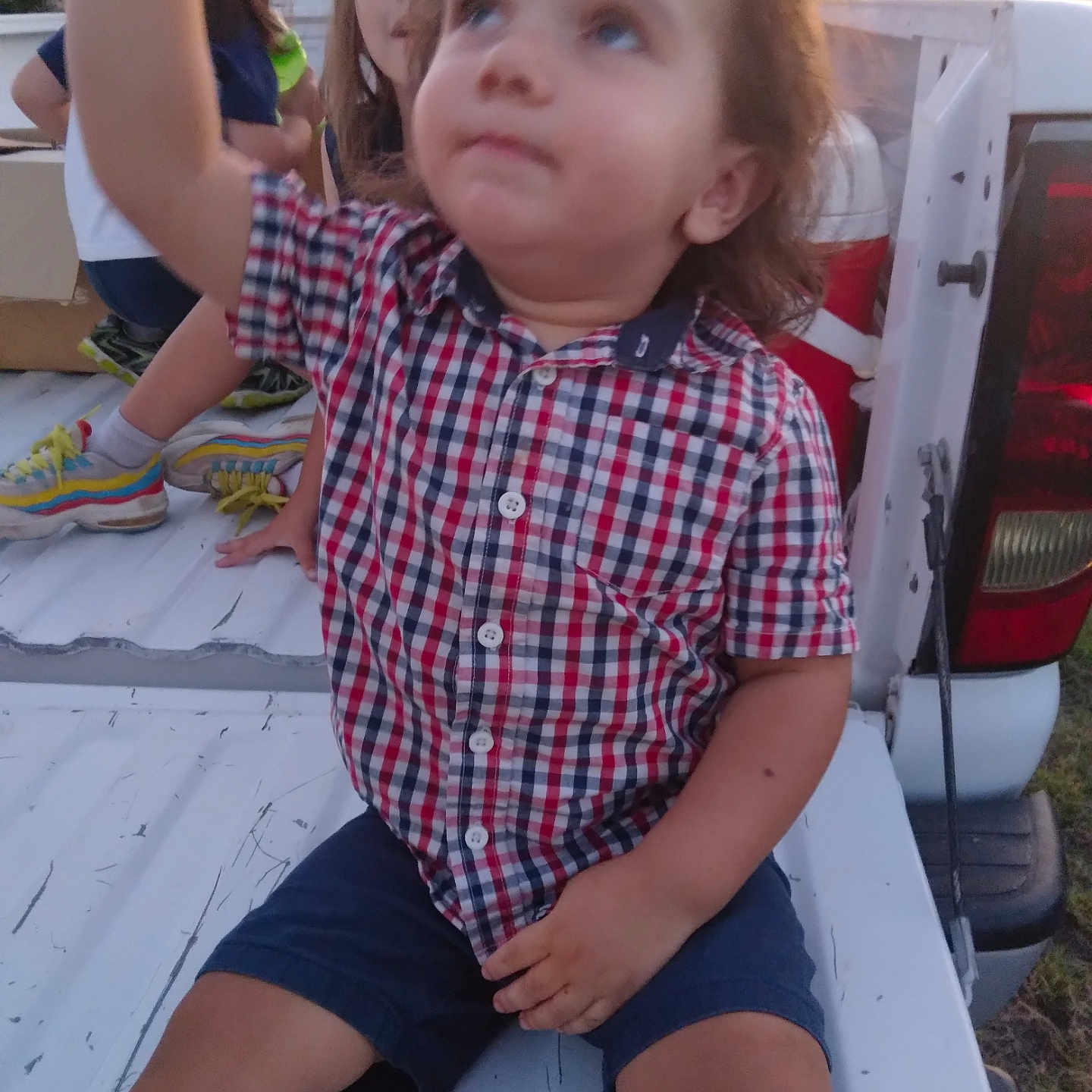 Josiah is registered to the contest to win money with this photo: bodypart, car, child, clothing, face, female, finger, footwear, girl, hand, head, person, photography, portrait, shirt, shoe, shorts, t_shirt, transportation, vehicle