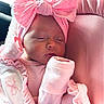 Blayne is registered to the contest to win money with this photo: baby, newborn, sleeping, pink, headband, bow, clothing, cushion, infant, soft, cute, portrait, rest, peaceful, closeup, child, indoors, blanket, hand, face