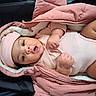 Olivia Joyner is registered to the contest to win money with this photo: adorable, baby, child, clothing, cozy, cute, expression, face, hands, indoor, infant, lying_down, newborn, person, pink_hat, pink_jacket, portrait, skin, soft, warm