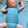 baby, sleeping, blue_onesie, blanket, infant, peaceful, arms_up, legs_spread, soft_texture, indoor, child, cute, resting, newborn, skin, head, foot, hand, clothing, portrait
