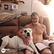 Bodie joined the competition — help win amazing prizes! affection, black_spots, blanket, book, comfort, couch, dog, glasses, home, indoors, living_room, man, pet, reading, relaxed, seated, shirtless, tattoo, wall_photos, white_dog