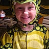 Konnor joined the competition — help win amazing prizes! celebration, child, childhood, clothing, costume, cute, dinosaur, face, fancy_dress, fun, green, happy, holiday, hood, indoor, person, playful, portrait, smile, yellow