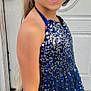 child, girl, smiling, dress, sequins, blue_dress, earrings, hoop_earrings, long_hair, blonde_hair, door, glass, decoration, outdoor, portrait, happy, person, fashion, accessory, standing